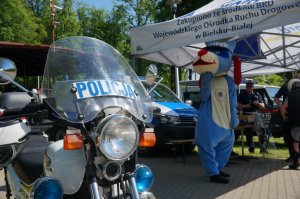 policyjny motocykl w tle sznupek oraz policjanci
