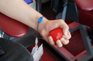 dłoń trzymająca czerwoną piłeczkę