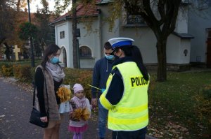 policjantka rozdaje odblaski przechodniom