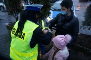 policjantka wręcza odblaski osobom