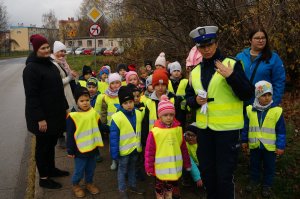 policjantka stoi obok dzieci dzieci stoją parami obok stoją wychowawczynie