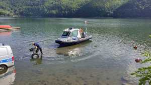 łódka pływająca na jeziorze obok wózek do wodowania