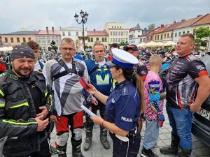 policjantka wręcza apteczkę motocyklową motocykliście