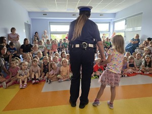 policjantka stoi z dziewczynką